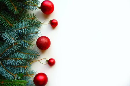 spruce branches with red balls on white background, top view, copy spaceの写真素材