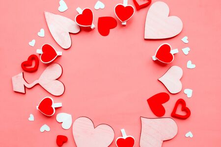 Round frame of hearts on pink background. Flat lay, top view, copy space. Valentine's Day greeting cardの写真素材