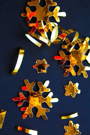 Golden Christmas decorations on black background. Flat lay, top view, verticalの写真素材