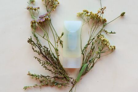 Cosmetic bottles and herbs on white background. Natural cosmetic product conceptの写真素材