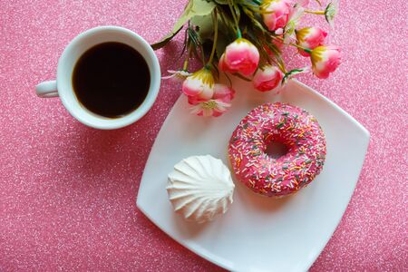 Flat lay photo with coffee cup, strawberry donut and bouquet of flowers. 8 march or Valentine's Day greeting cardの写真素材