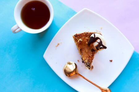Sliced tasty chocolate cake and tea cup, top viewの写真素材