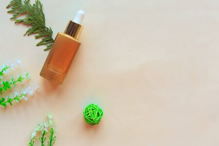 Cosmetic bottle and herbs on white background. Flat lay, top view. Natural cosmetic product conceptの写真素材