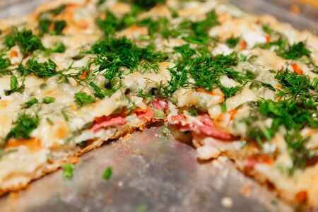 Slice of homemade pizza on metal sheetの写真素材