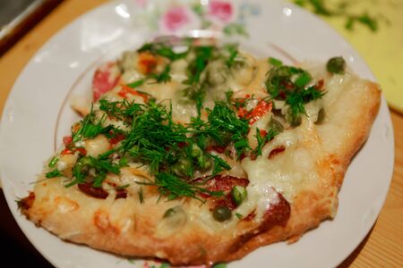 piece of pizza on white plate, top viewの写真素材