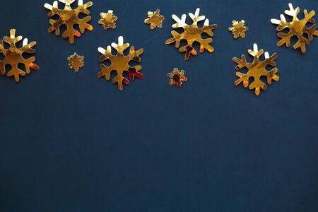 Golden decorations on black background. Flat lay, top view, copy space. Merry Christmas and Happy New Yearの写真素材