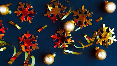 Golden decorations on black background. Flat lay, top view, copy space. Merry Christmas and Happy New Yearの写真素材