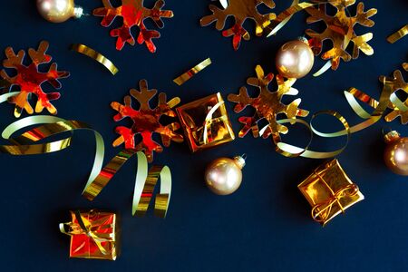 Golden decorations on black background. Flat lay, top view, copy space. Merry Christmas and Happy New Yearの写真素材