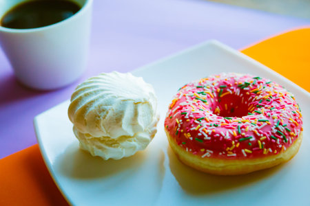 white marshmallow and pink donut on white plate