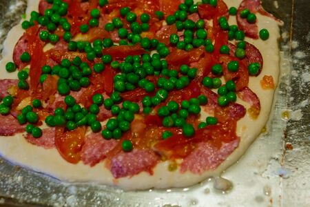 tasty homemade pizza with vegetables and salami, top viewの写真素材