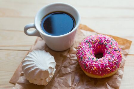 zefir, donut and coffee cup on crumpled paper, top viewの写真素材