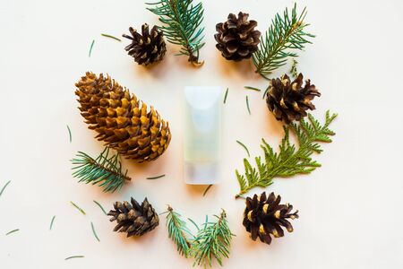 Cosmetic bottle, cones and spruce branches on white background, top view. Natural cosmetic products conceptの写真素材