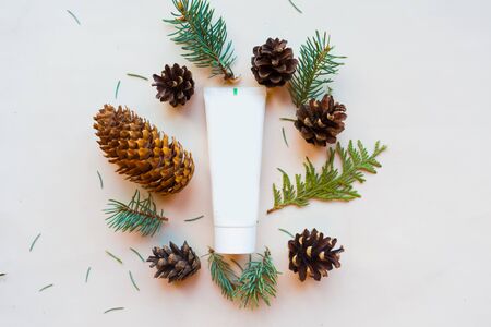Cosmetic bottle, cones and spruce branches on white background, top view. Natural cosmetic products conceptの写真素材