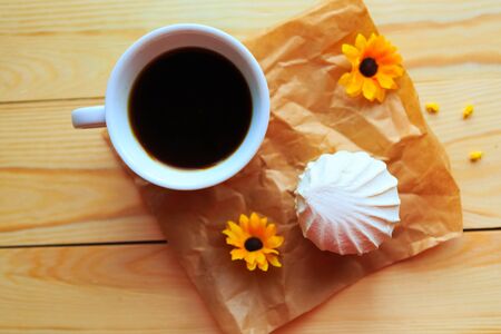 coffee cup and zefir on wooden background, top viewの写真素材