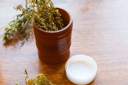 Herbs in wooden bowl. Natural cosmetics product conceptの写真素材