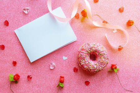 White mockup blank and donut on glitter pink background. Valentine's Day greeting card の写真素材