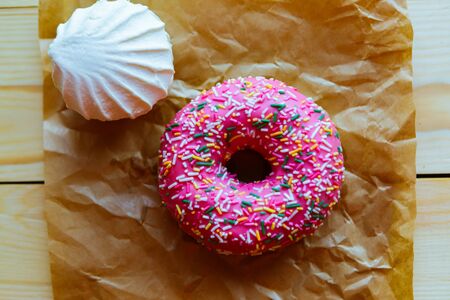 zefir and donut on crumpled paper, top viewの写真素材
