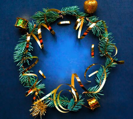 Christmas wreath with golden decorations on black background. Flat lay, top view, copy space. Merry Christmas and Happy New Year. Beautiful Xmas greeting cardの写真素材