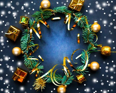 Christmas wreath with golden decorations on black background. Flat lay, top view, copy space. Merry Christmas and Happy New Year. Beautiful Xmas greeting cardの写真素材