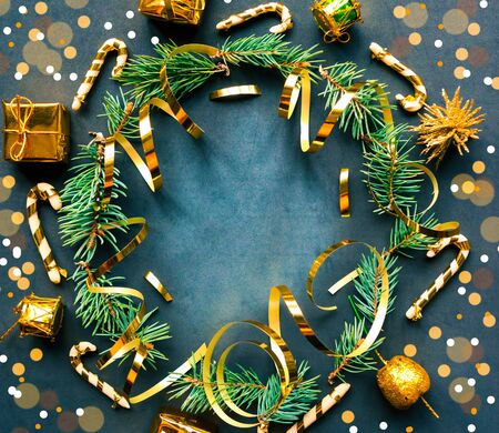 Christmas wreath with golden decorations on black background. Flat lay, top view, copy space. Merry Christmas and Happy New Year. Beautiful Xmas greeting cardの写真素材