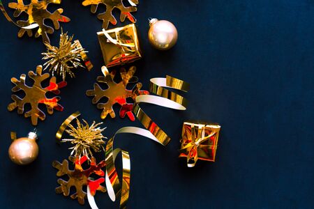 Flat lay photo with Christmas golden decorations on black background. Merry Christmas ans Happy new Year. Top view, copy space. Xmas greeting cardの写真素材