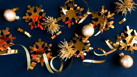 Flat lay photo with Christmas golden decorations on black background. Merry Christmas and Happy new Year. Top view, copy space. Xmas greeting cardの写真素材