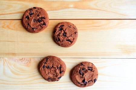 chocolate chip cookies and coffee cup on wooden background, flat lay, top viewの写真素材