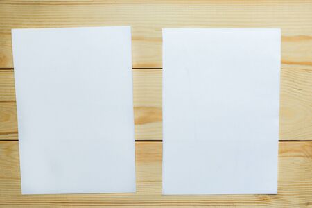 Two white mockup blanks on wooden background. Flat lay, top view, copy spaceの写真素材