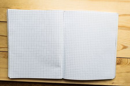 Open notebook on wooden backgroundの写真素材