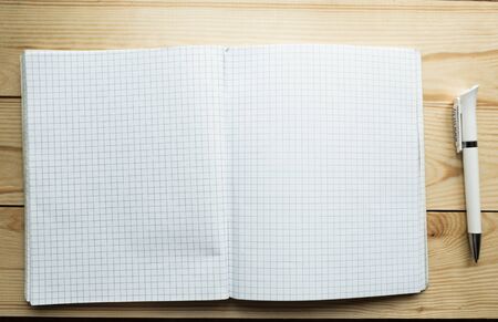 Open notebook and pen on wooden backgroundの写真素材