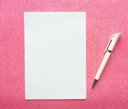 White mockup blank and pen on glitter pink backgroundの写真素材