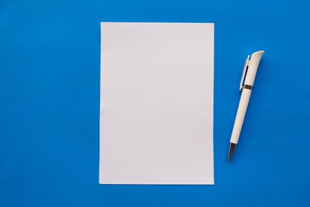 White mockup blank and pen on blue backgroundの写真素材