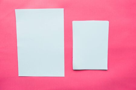 Two white mockup blanks on pink background. Flat lay, top view, copy spaceの写真素材