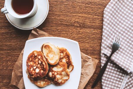 Sweet homemade pancakes and tea cup, flat lay, top viewの写真素材