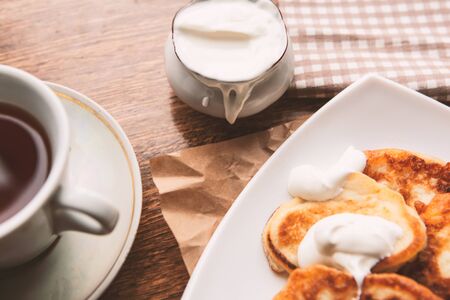 Sweet homemade pancakes and tea cup, flat lay, top viewの写真素材