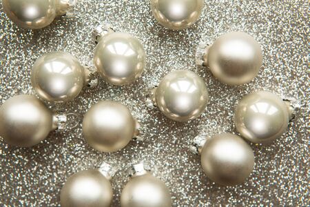 Silver Christmas baubles on silver glitter backgroundの写真素材