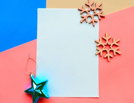 Christmas mockup greeting card with snowflakes and decorations on blue and pink backgroundの写真素材