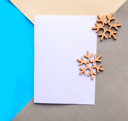 Flat lay photo with white mockup blank and wooden snowflakes - Xmas greeting cardの写真素材