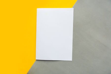White paper blank on gray and yellow paper backgroundの写真素材