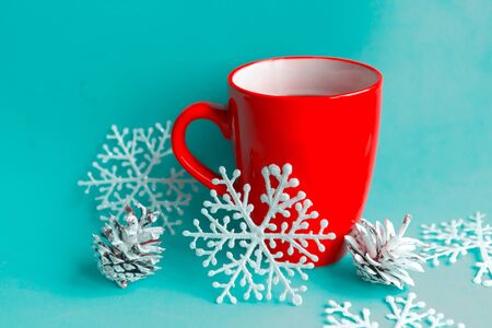 Red coffee cup and Christmas decorations on blue background. Beautiful Xmas greeting cardの写真素材