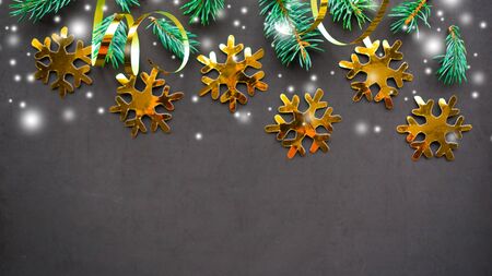 Blue spruce branches with golden decorations on black background. Merry Christmas and Happy New year. Flat lay, top view, copy spaceの写真素材