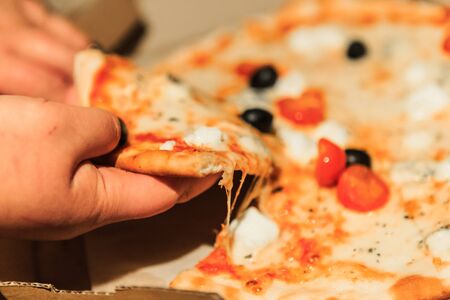 Piece of tasty salami pizza with cheese, closeupの写真素材