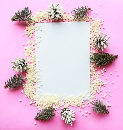 Christmas composition. White mockup blank and Christmas decorations on pink background. Christmas, winter, new year concept. Flat lay, top view, copy spaceの写真素材