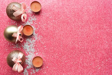 Christmas balls on pink glitter background. Flat lay, top view, copy space. Xmas greeting card, bannerの写真素材