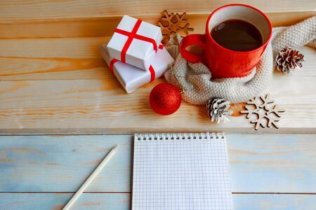 Red coffee cup and Christmas decorations on wooden background. Cozy winter still life conceptの写真素材