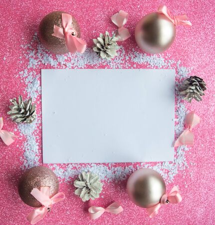 Christmas composition. White mockup blank and Christmas decorations on pink background. Christmas, winter, new year concept. Flat lay, top view, copy spaceの写真素材