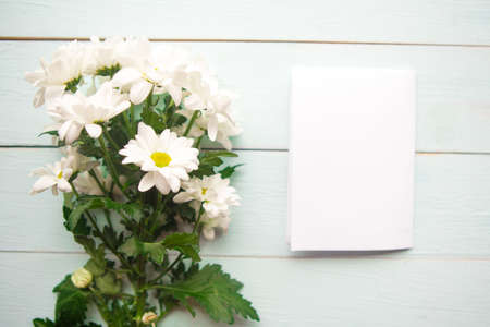 bouquet of white chrysanthemums and white mockup blank, top viewの写真素材