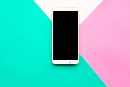 Mockup phone on geometric pink,white and green paper background textureの写真素材