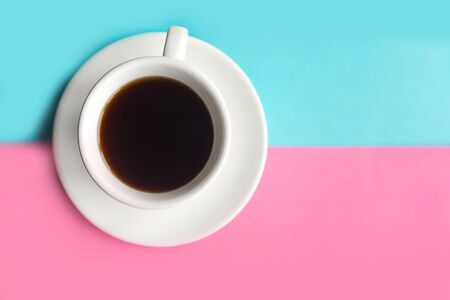 Coffee cup on blue and pink pastel background. Minimal conceptの写真素材