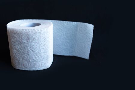 White toilet paper roll on black background, hygiene concept.の写真素材